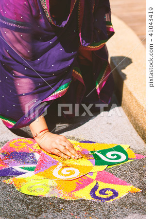 Women decorating traditional rice art (Rangoli) Women decorating traditional rice art (Rangoli) 41043419