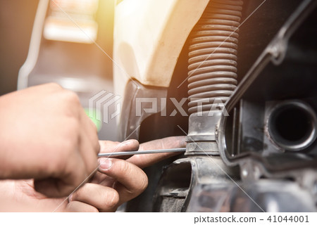 Man hands repairing motorcycle. 41044001