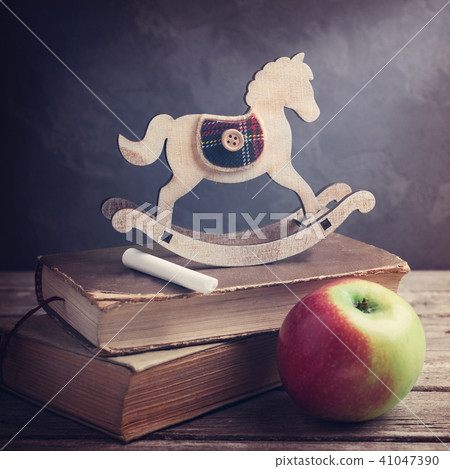 Old books and wooden toy horse Old books and wooden toy horse 41047390