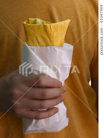 falafel with vegetables lavash vegan wrap in hand 41047404