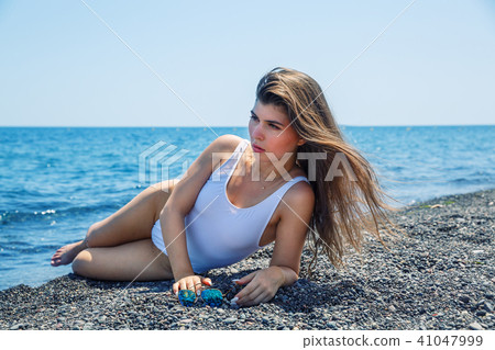 Woman sunbathing on the beach Woman sunbathing on the beach 41047999