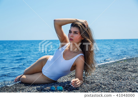 Woman sunbathing on the beach Woman sunbathing on the beach 41048000