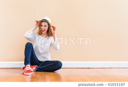 Happy young woman smiling in a big open room Happy young woman smiling in a big open room 41055197