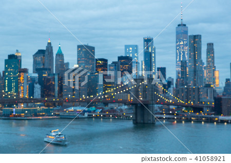 Out of focus image of Brooklyn Bridge and Lower Manhattan skyline at night, New York city, USA. 41058921