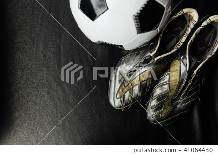Flat lay soccer football accessories on a dark leather background. Mock-up with copy space for text. 41064430