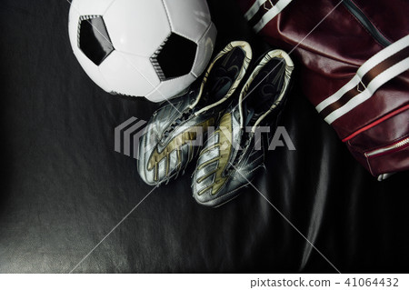 Flat lay soccer football accessories on a dark leather background. Mock-up with copy space for text. 41064432