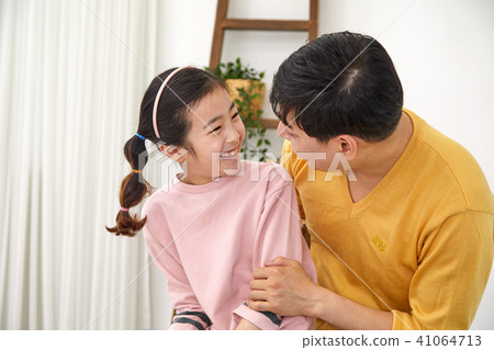Happy home with daughter and dad playing on sofa Happy home with daughter and dad playing on sofa 41064713
