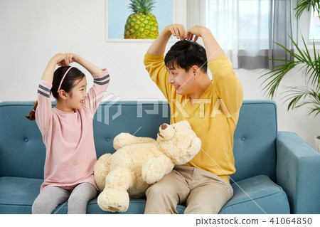Happy home with daughter and dad playing on sofa 41064850
