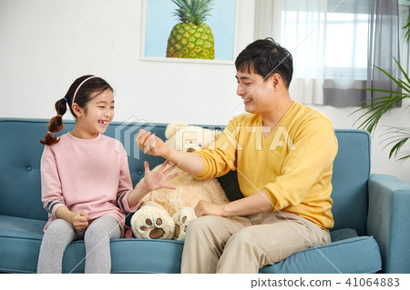 Happy home with daughter and dad playing on sofa Happy home with daughter and dad playing on sofa 41064883