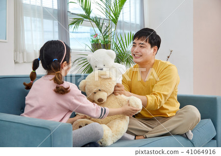 Happy home with daughter and dad playing on sofa Happy home with daughter and dad playing on sofa 41064916