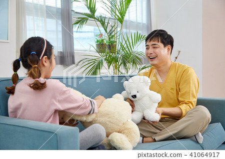 Happy home with daughter and dad playing on sofa 41064917