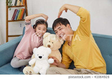 Happy home with daughter and dad playing on sofa Happy home with daughter and dad playing on sofa 41064928