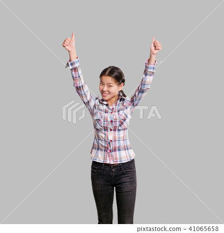 Winning concept. Asian girl shows well done Winning concept. Asian girl shows well done 41065658