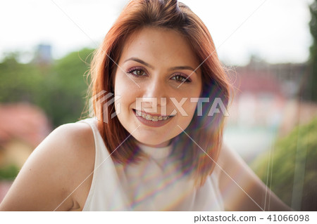 Portrait of gorgeous redhaired woman in summer rays 41066098
