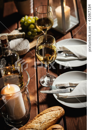 romantic dinner with two glasses of wine and snacks on an old wooden table romantic dinner with two glasses of wine and snacks on an old wooden table 41067184