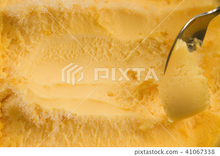 scooping with spoon orange sorbet 41067338