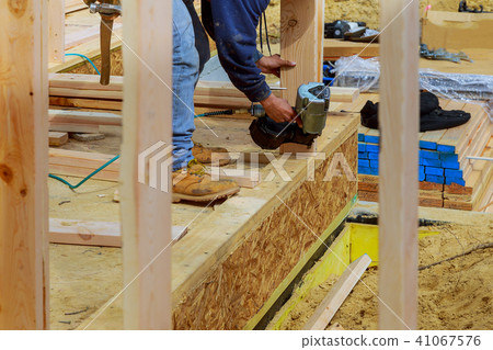 Building contractor worker with air nailgun nailer Building contractor worker with air nailgun nailer 41067576