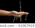 Woman's hands with water splash 41067919