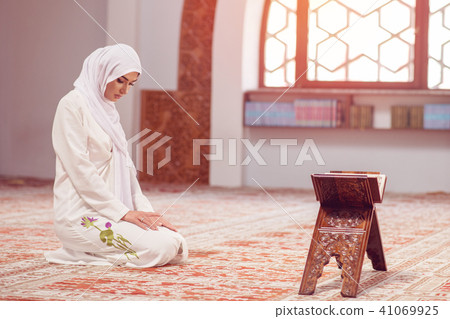 Young beautiful Muslim Woman Praying In Mosque 41069925