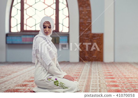 Young beautiful Muslim Woman Praying In Mosque 41070058