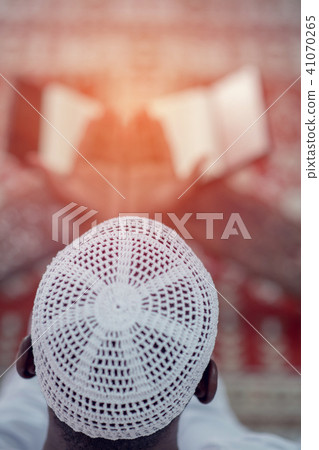 Top viewv of African Muslim Man Making Traditional Prayer To God While Wearing A Traditional Cap 41070265