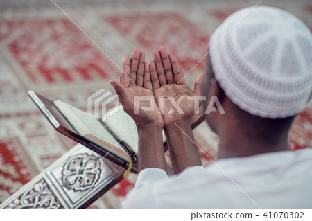 African Muslim Man Making Traditional Prayer To God While Wearing Dishdasha African Muslim Man Making Traditional Prayer To God While Wearing Dishdasha 41070302