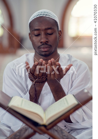 African Muslim Man Making Traditional Prayer To God While Wearing Dishdasha 41070330