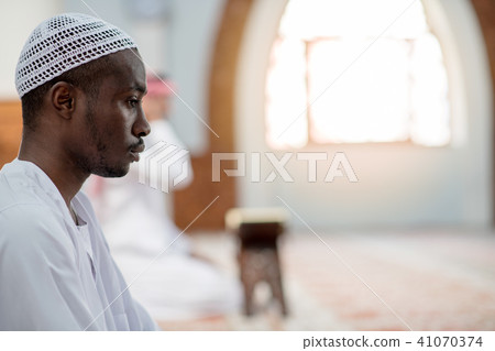 African Muslim Man Making Traditional Prayer To God While Wearing Dishdasha 41070374