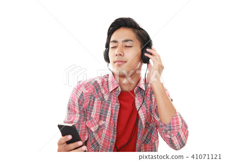 A smiling male listening to music A smiling male listening to music 41071121