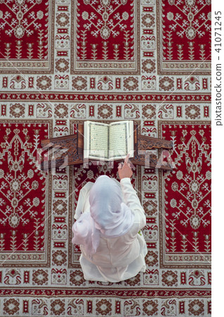 Top aerial view Young beautiful Muslim Woman Praying In Mosque Top aerial view Young beautiful Muslim Woman Praying In Mosque 41071245