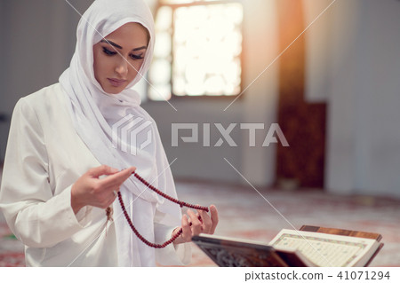 Young beautiful Muslim Woman Praying In Mosque 41071294
