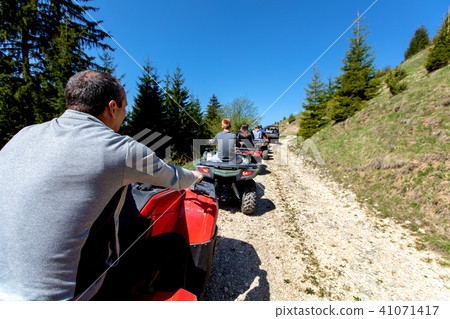 A tour group travels on ATVs and UTVs on the mountains 41071417