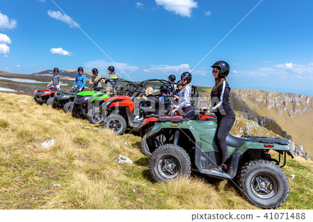 Friends driving off-road with quad bike or ATV and UTV vehicles 41071488