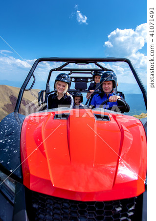 Friends driving off-road with quad bike or ATV and UTV vehicles 41071491