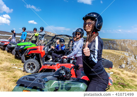 Friends driving off-road with quad bike or ATV and UTV vehicles 41071499
