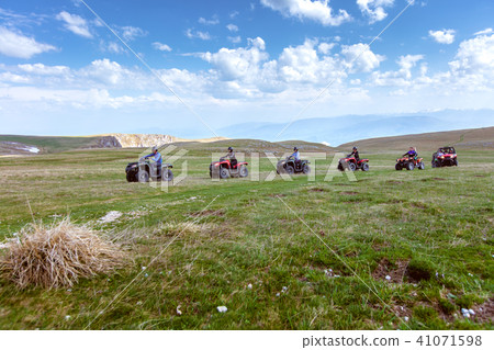 Friends driving off-road with quad bike or ATV and UTV vehicles Friends driving off-road with quad bike or ATV and UTV vehicles 41071598