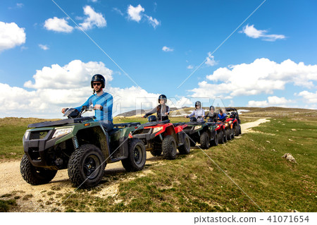 Friends driving off-road with quad bike or ATV and UTV vehicles 41071654