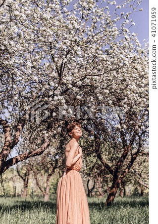 Girl in a pink dress is posing in a garden full Girl in a pink dress is posing in a garden full 41071959
