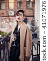 Stylish woman is standing on the balcony  41071976