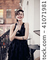 Stylish woman is standing on the balcony  41071981