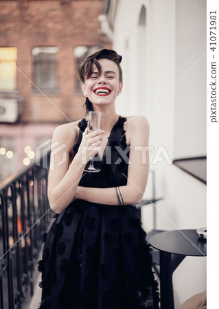 Stylish woman is standing on the balcony Stylish woman is standing on the balcony 41071981