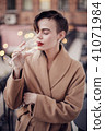 Stylish woman is standing on the balcony  41071984