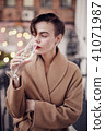 Stylish woman is standing on the balcony  41071987