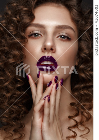 Beautiful girl with evening make-up, purple lips, curls and design manicure nails. beauty face. Beautiful girl with evening make-up, purple lips, curls and design manicure nails. beauty face. 41074003