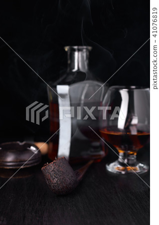 Glass of whiskey with smoking cigar. Glass of whiskey with smoking cigar. 41076819