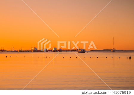 sunrise on the red sea ships and pier orange sky 41076919