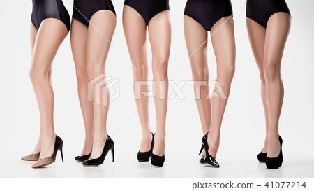 Group from beautiful young women posing isolated on a white background Group from beautiful young women posing isolated on a white background 41077214