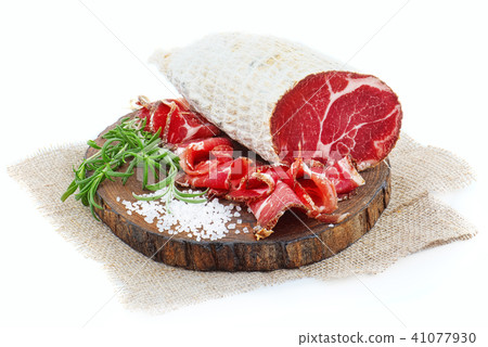 Sliced cured coppa with a sprig of rosemary. Sliced cured coppa with a sprig of rosemary. 41077930