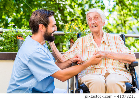 Geriatric nurse holding hand of old woman in rest home Geriatric nurse holding hand of old woman in rest home 41078213