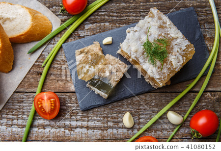 Homemade jelly meat with mustard, bread, tomatoes and garlic on the table. Holodets 41080152